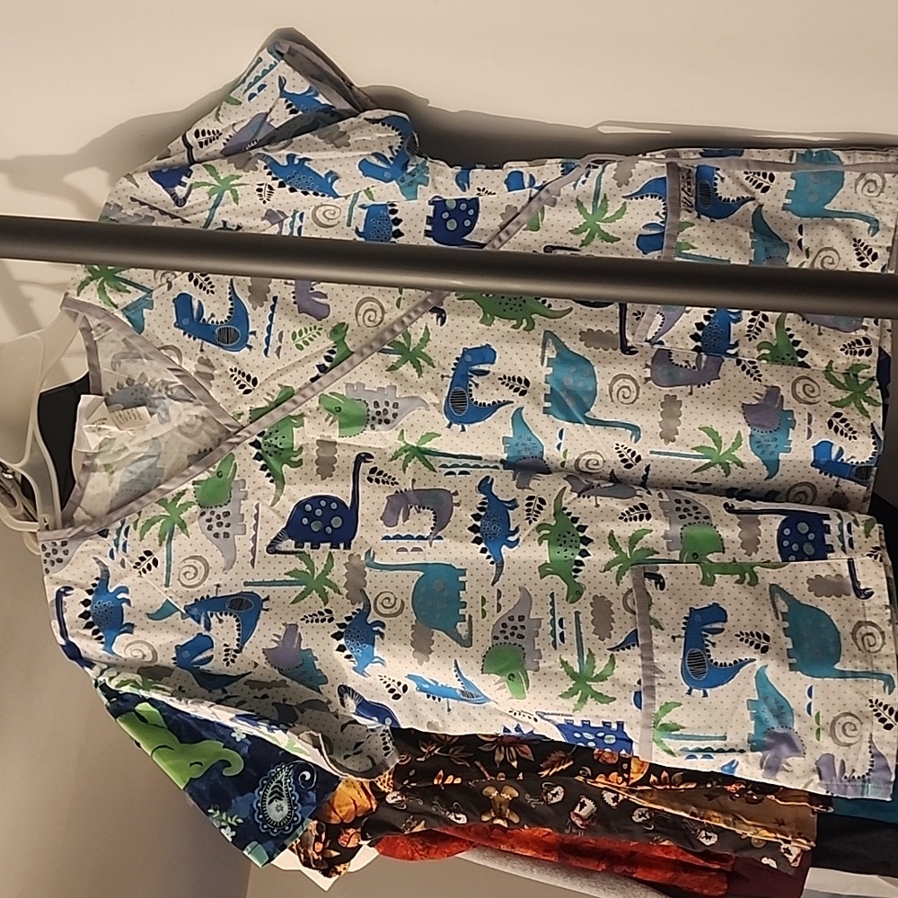 White, blue, green, dizzy dinosaurs: tie medical top